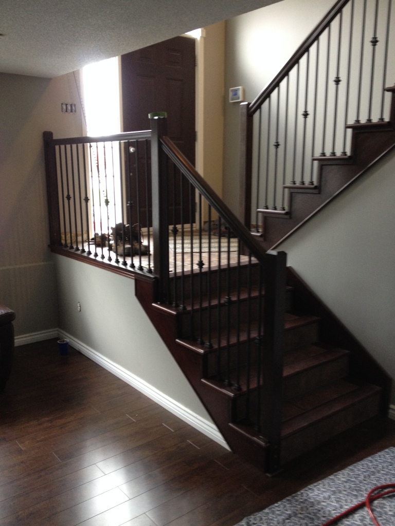 Stained maple railing renovation with black metal spindles KP Carpentry