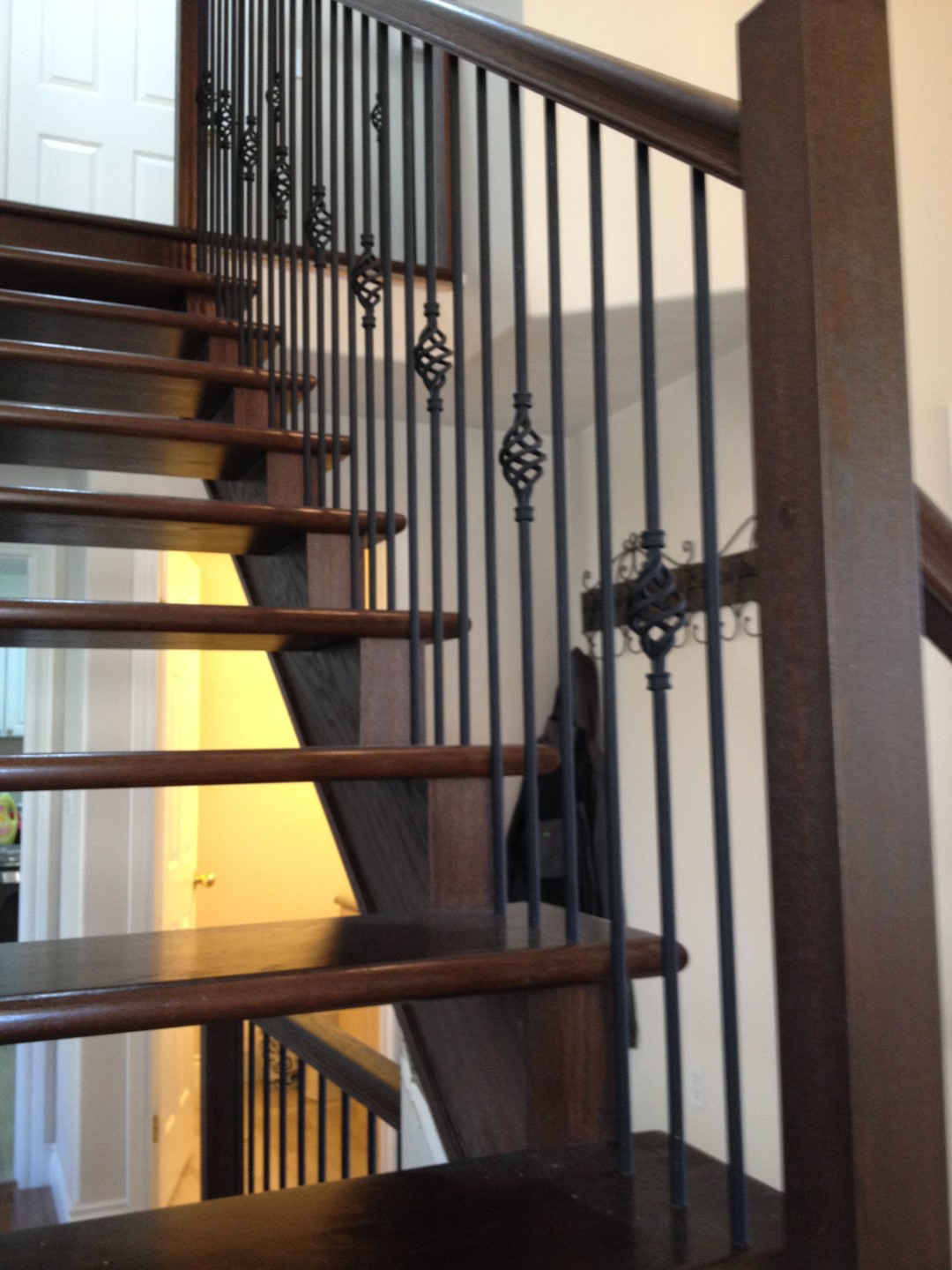 Custom open riser staircase with birdcage wrought iron spindles KP
